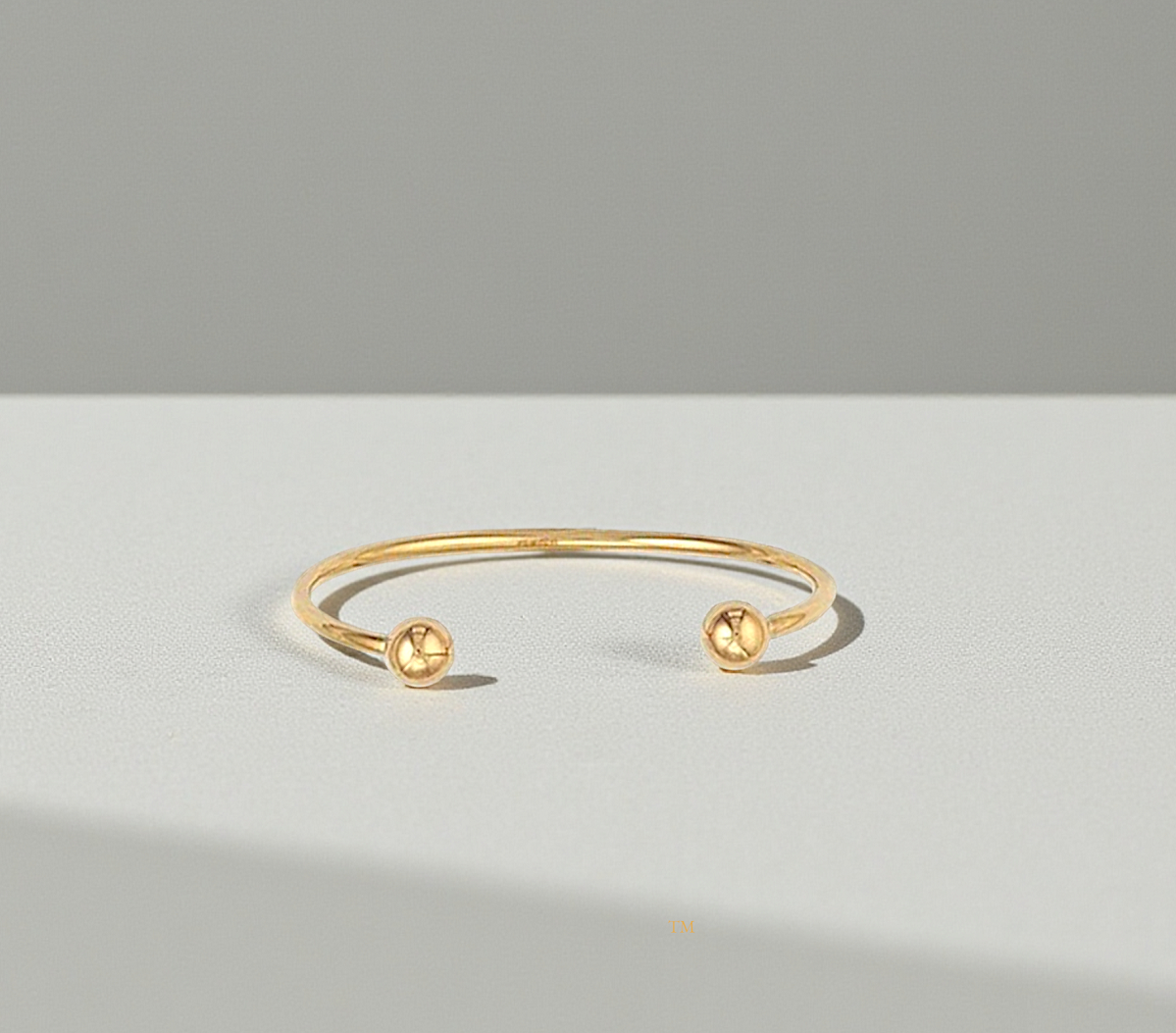 Hollow 9K Gold Baby Torque Bangle. Pobjoy Diamonds